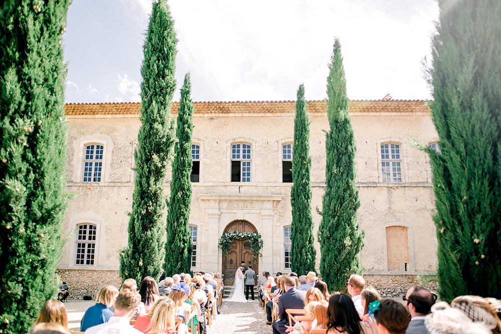 classic destination wedding reception with pillar candles and bride in spaghetti strap dress