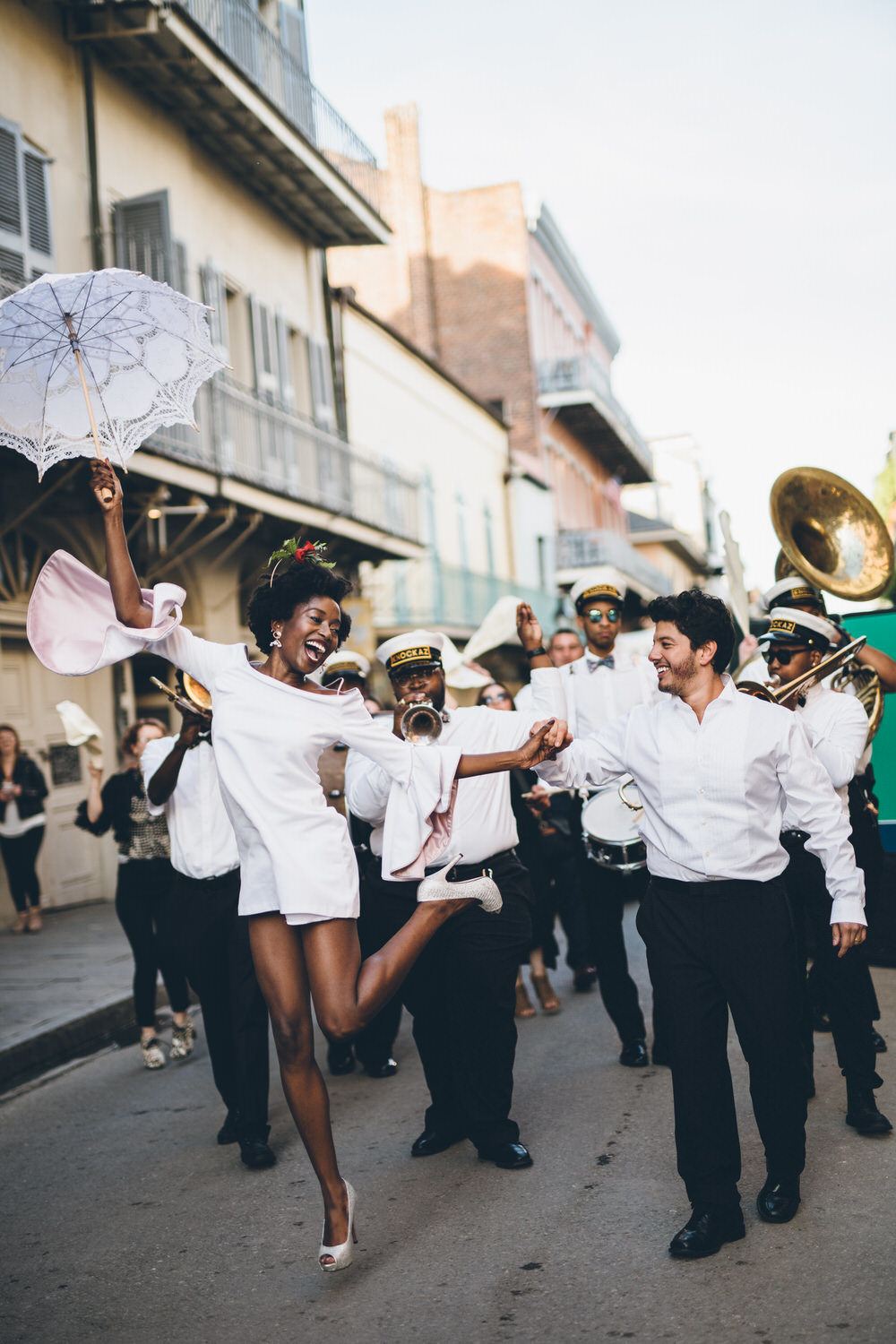 bride and groom dance down streets of New Orleans